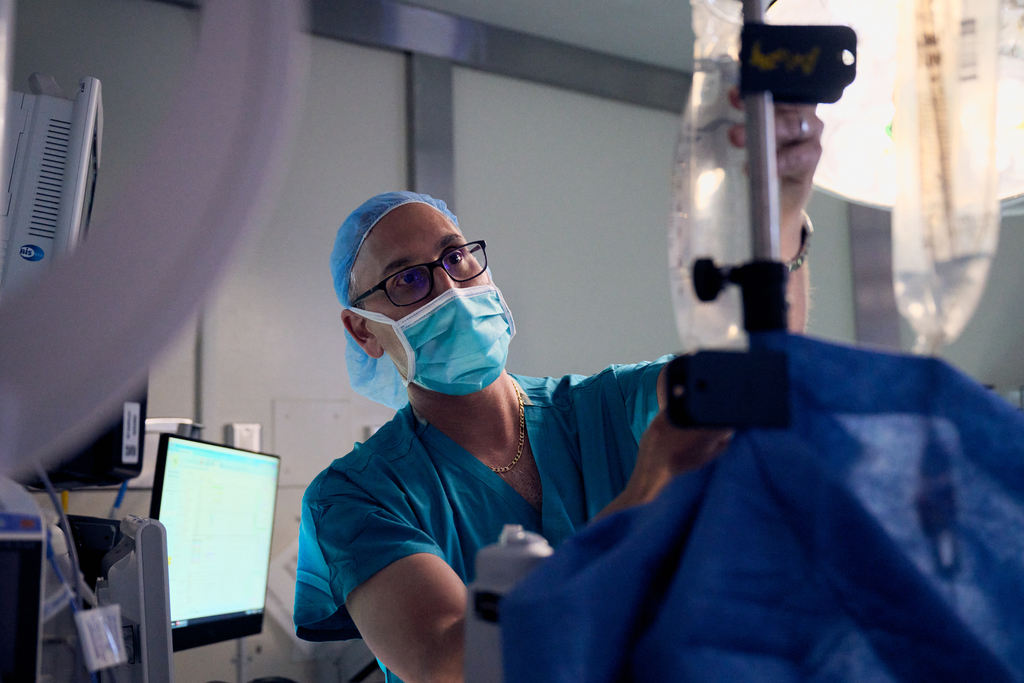 Clinician inspecting an IV bag