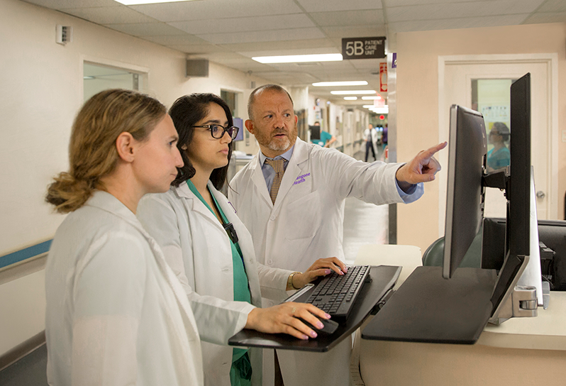 Clinicians using a computer 